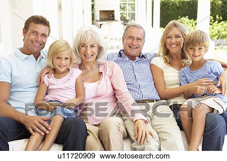 Extended Family Relaxing Together On Sofa View Large Photo Image Stock Photo - Extended Family Relaxing Together On Sofa. Fotosearch