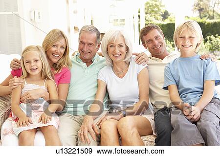 Stock Photo - Extended Family Relaxing Together On Sofa. Fotosearch