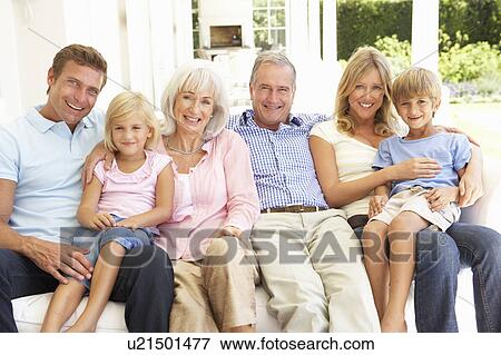 Stock Photo - Extended Family Relaxing Together On Sofa. Fotosearch