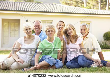 Stock Image - Extended Family Sitting Outside Dream Home. Fotosearch