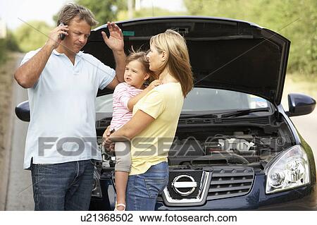 Stock Image - Family Broken Down On Country Road. Fotosearch