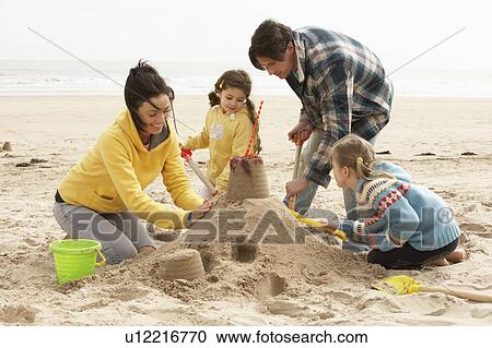 Family Building Sandcastle On Winter Beach View Large Photo Image Stock Image - Family Building Sandcastle On Winter Beach. Fotosearch