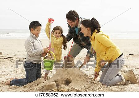 Family Building Sandcastle On Winter Beach View Large Photo Image Stock Image - Family Building Sandcastle On Winter Beach. Fotosearch