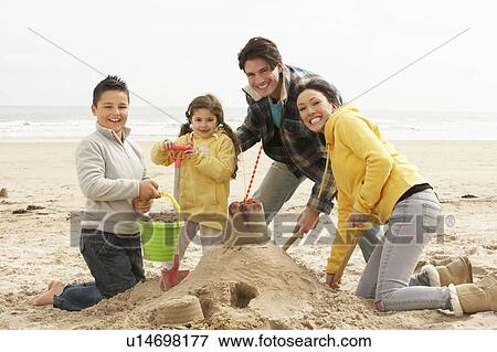 Family Building Sandcastle On Winter Beach View Large Photo Image Stock Photo - Family Building Sandcastle On Winter Beach. Fotosearch