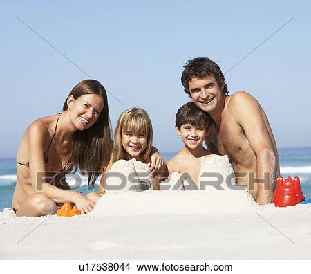Family Building Sandcastles On Beach Holiday View Large Photo Image Picture - Family Building Sandcastles On Beach Holiday. Fotosearch