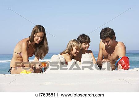 Family Building Sandcastles On Beach Holiday View Large Photo Image Stock Image - Family Building Sandcastles On Beach Holiday. Fotosearch