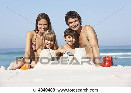 Family Building Sandcastles On Beach Holiday View Large Photo Image Stock Photo - Family Building Sandcastles On Beach Holiday. Fotosearch
