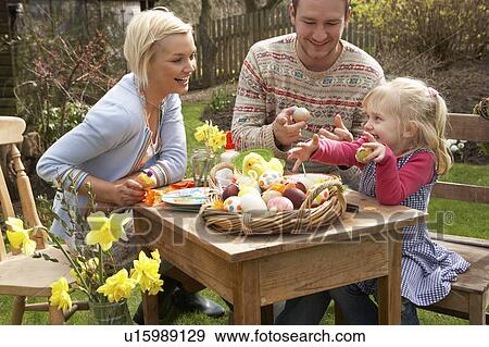 Family Decorating Easter Eggs On Table Outdoors View Large Photo Image Stock Photo - Family Decorating Easter Eggs On Table Outdoors . Fotosearch
