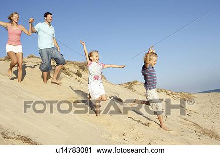 Family Enjoying Beach Holiday Running Down Dune View Large Photo Image Stock Image - Family Enjoying Beach Holiday Running Down Dune. Fotosearch