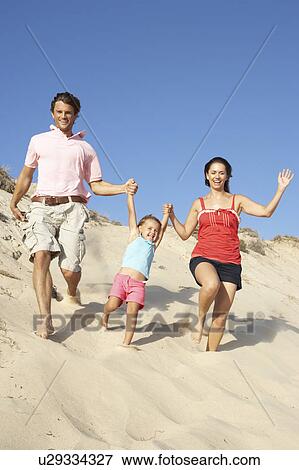 Family Enjoying Beach Holiday Running Down Dune View Large Photo Image Stock Photo - Family Enjoying Beach Holiday Running Down Dune. Fotosearch