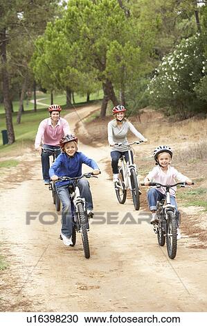 Family enjoying bike ride in park View Large Photo Image Stock Image - Family enjoying bike ride in park. Fotosearch