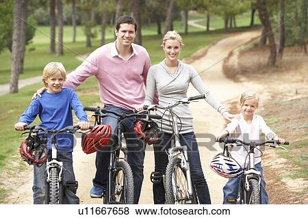 Family enjoying bike ride in park View Large Photo Image Stock Photo - Family enjoying bike ride in park. Fotosearch