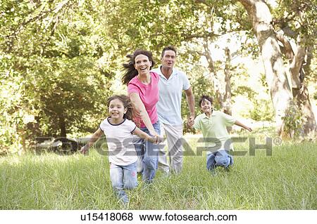 Stock Photo - Family Enjoying Walk In Park. Fotosearch