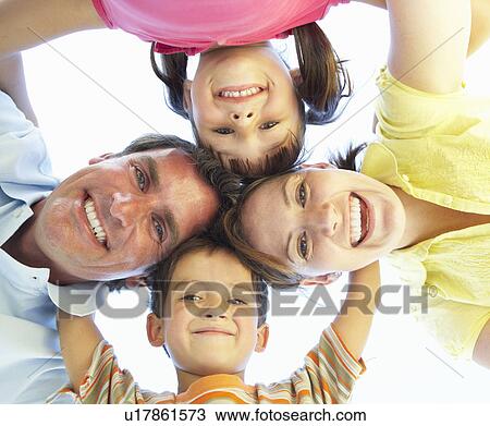 Stock Image - Family Group Looking Down Into Camera. Fotosearch