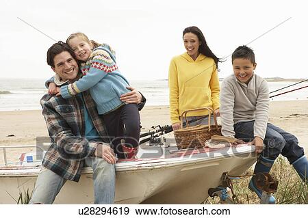 Family Group Sitting On Boat With Fishing Rod On Winter Beach View Large Photo Image Stock Photo - Family Group Sitting On Boat With Fishing Rod On Winter Beach. Fotosearch