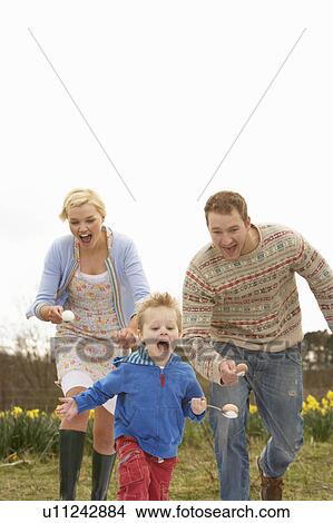 Picture - Family Having Egg And Spoon Race. Fotosearch