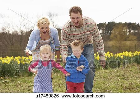 Stock Photograph - Family Having Egg And Spoon Race. Fotosearch