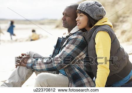 Stock Image - Family Having Fun On Winter Beach. Fotosearch