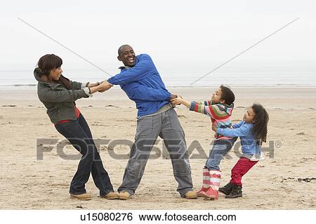 Family Having Fun On Winter Beach View Large Photo Image Stock Photograph - Family Having Fun On Winter Beach. Fotosearch