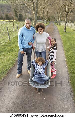Family Having Ride In Wheelbarrow In Countryside View Large Photo Image Stock Image - Family Having Ride In Wheelbarrow In Countryside. Fotosearch