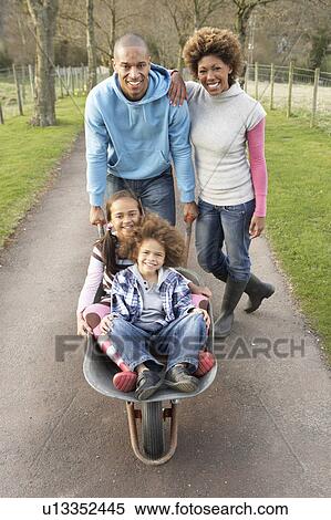 Family Having Ride In Wheelbarrow In Countryside View Large Photo Image Stock Photography - Family Having Ride In Wheelbarrow In Countryside. Fotosearch