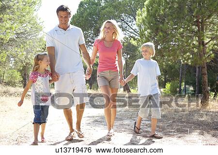 Stock Photograph - Family, parents and children, walking, walk together in park. Fotosearch