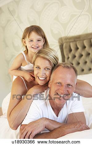 Family Relaxing In Bedroom View Large Photo Image Stock Photograph - Family Relaxing In Bedroom. Fotosearch