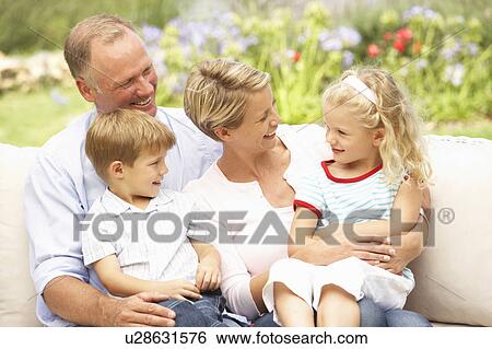 Family Relaxing In Garden View Large Photo Image Stock Photograph - Family Relaxing In Garden. Fotosearch