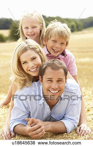 Family Relaxing In Summer Harvested Field View Large Photo Image Stock Photo - Family Relaxing In Summer Harvested Field. Fotosearch