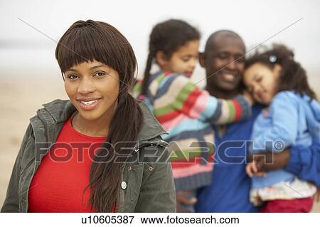 Family Relaxing On Winter Beach Break View Large Photo Image Stock Photo - Family Relaxing On Winter Beach Break . Fotosearch