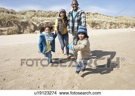 Family Running On Winter Beach View Large Photo Image Picture - Family Running On Winter Beach. Fotosearch