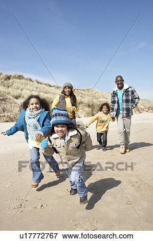 Family Running On Winter Beach View Large Photo Image Stock Photo - Family Running On Winter Beach. Fotosearch