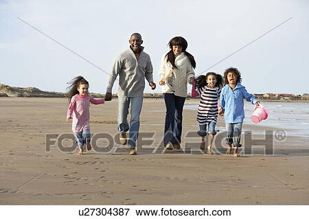 Family Running On Winter Beach View Large Photo Image Stock Photo - Family Running On Winter Beach. Fotosearch