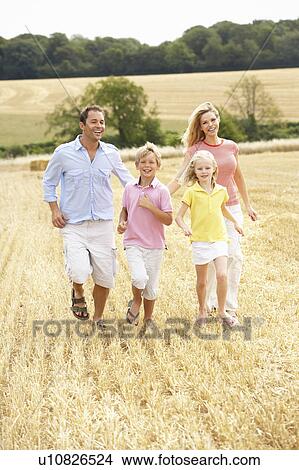 Family Running Together Through Summer Harvested Field View Large Photo Image Picture - Family Running Together Through Summer Harvested Field. Fotosearch