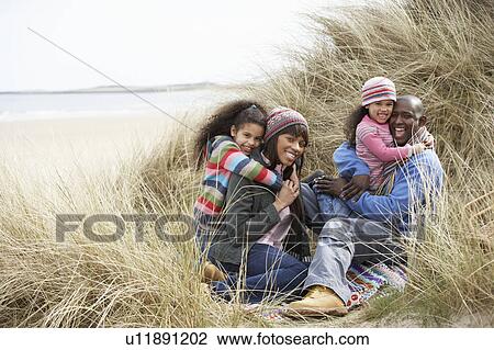 Family Sitting In Dunes Enjoying Picnic On Winter Beach View Large Photo Image Stock Image - Family Sitting In Dunes Enjoying Picnic On Winter Beach. Fotosearch