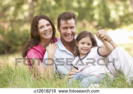 Family Sitting In Long Grass In Park View Large Photo Image Stock Photo - Family Sitting In Long Grass In Park. Fotosearch