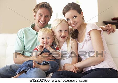 Family Sitting On Sofa At Home Together View Large Photo Image Stock Image - Family Sitting On Sofa At Home Together. Fotosearch