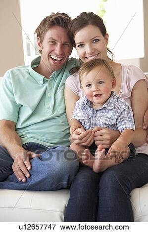 Family Sitting On Sofa At Home Together View Large Photo Image Stock Photo - Family Sitting On Sofa At Home Together. Fotosearch