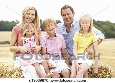 Family Sitting On Straw Bales In Harvested Field View Large Photo Image Stock Image - Family Sitting On Straw Bales In Harvested Field. Fotosearch