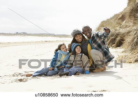 Family Sitting On Winter Beach View Large Photo Image Stock Image - Family Sitting On Winter Beach. Fotosearch