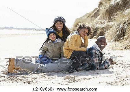 Family Sitting On Winter Beach View Large Photo Image Stock Photo - Family Sitting On Winter Beach. Fotosearch