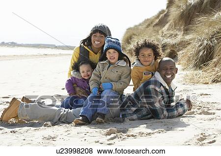 Family Sitting On Winter Beach View Large Photo Image Stock Photo - Family Sitting On Winter Beach. Fotosearch