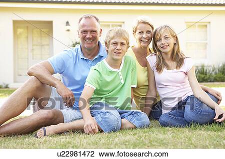 Stock Image - Family Sitting Outside Dream Home. Fotosearch