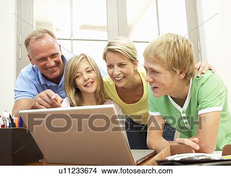 Family Using Laptop At Home View Large Photo Image Picture - Family Using Laptop At Home. Fotosearch