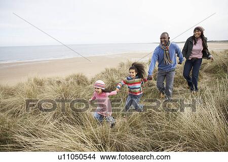 Family Walking Along Dunes On Winter Beach View Large Photo Image Picture - Family Walking Along Dunes On Winter Beach. Fotosearch