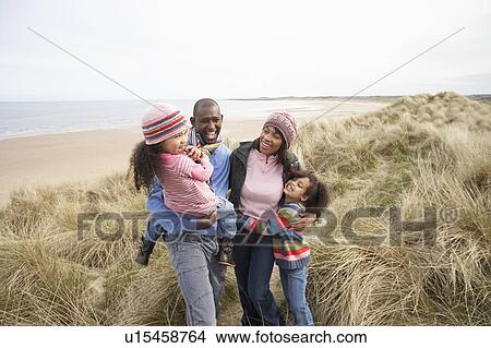 Picture - Family Walking Along Dunes On Winter Beach. Fotosearch