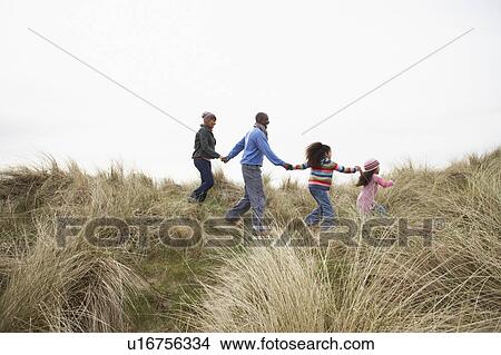 Family Walking Along Dunes On Winter Beach View Large Photo Image Picture - Family Walking Along Dunes On Winter Beach. Fotosearch