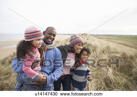 Family Walking Along Dunes On Winter Beach View Large Photo Image Stock Image - Family Walking Along Dunes On Winter Beach. Fotosearch