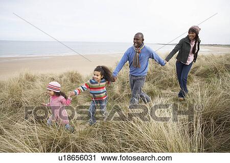 Family Walking Along Dunes On Winter Beach View Large Photo Image Stock Image - Family Walking Along Dunes On Winter Beach. Fotosearch