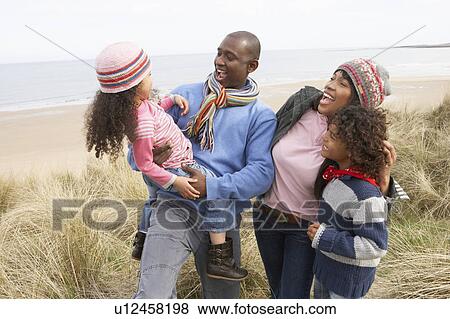 Stock Photo - Family Walking Along Dunes On Winter Beach. Fotosearch